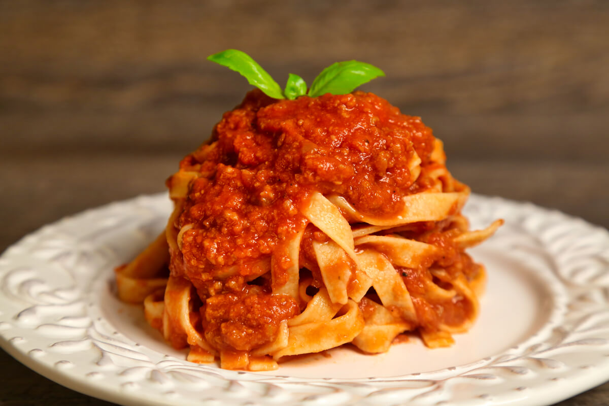 Developing robust flavors takes time, but cooking our traditional bolognese sauce slowly allows each ingredient to stand out while creating the perfect texture. 
