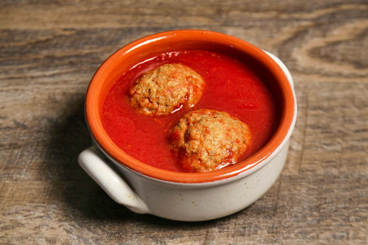 A simple classic with an artisan twist! To make our meatballs we start from scratch and use only the finest ingredients. We begin by grinding our own cheese and baking our own bread (using just our semolina and yeast) to make our own breadcrumbs. When we say no preservatives, we mean it, even if that means added steps and effort in our cooking process. Our well seasoned Italian meatballs are incredibly tender and served with our signature tomato sauce.